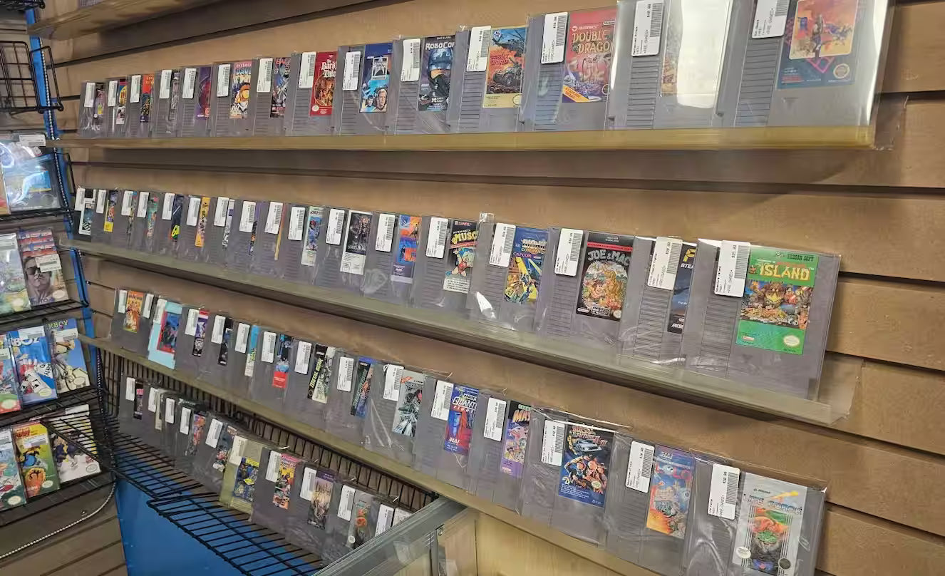 Multiple shelves with Nintendo Entertainment System Games spread across.